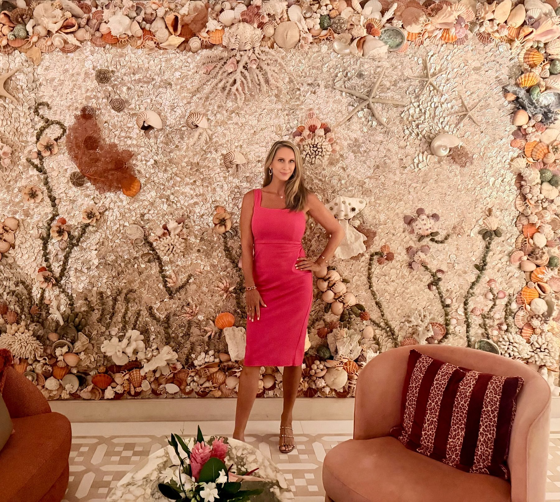 Kelly O’Shea against a shell-work wall in a Palm Beach hotel